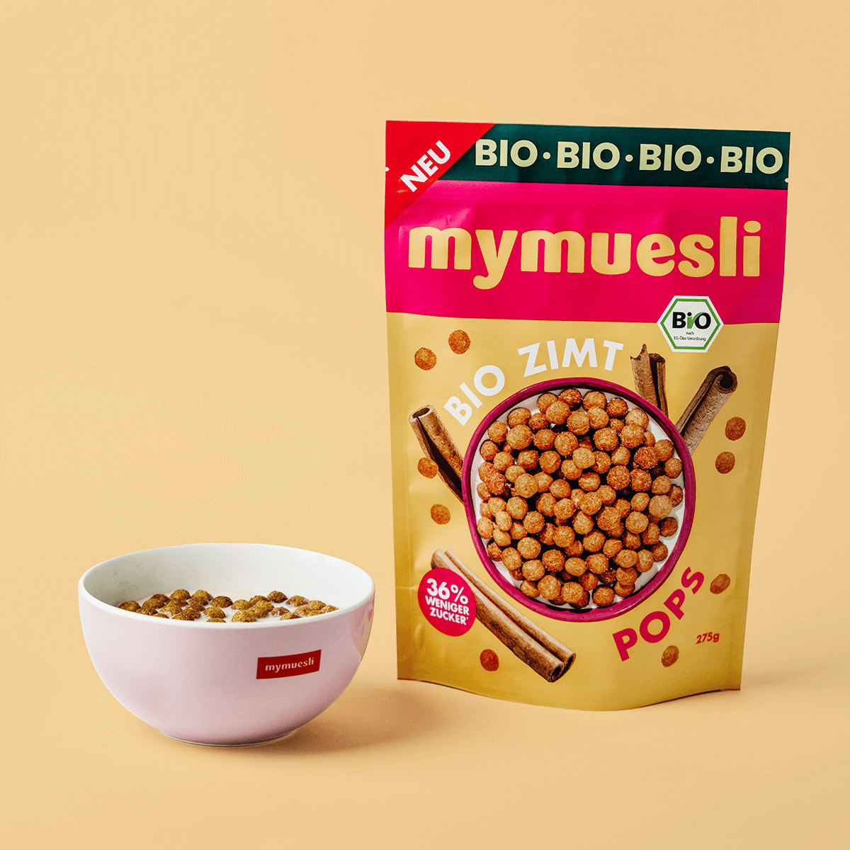 mymuesli Bio Zimt Pops in Packung und mymuesli Schale mit Milch